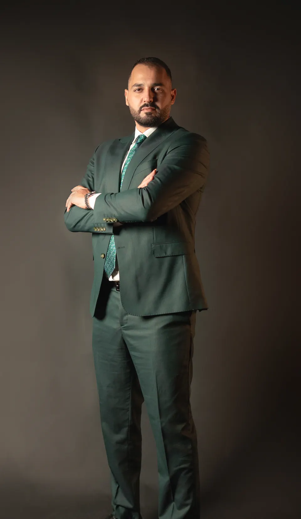 Othman Ballout standing at full length with his arms crossed.